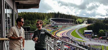 Guests enjoying a glass of Champagne on the balcony of the Gold 2 VIP Lounge