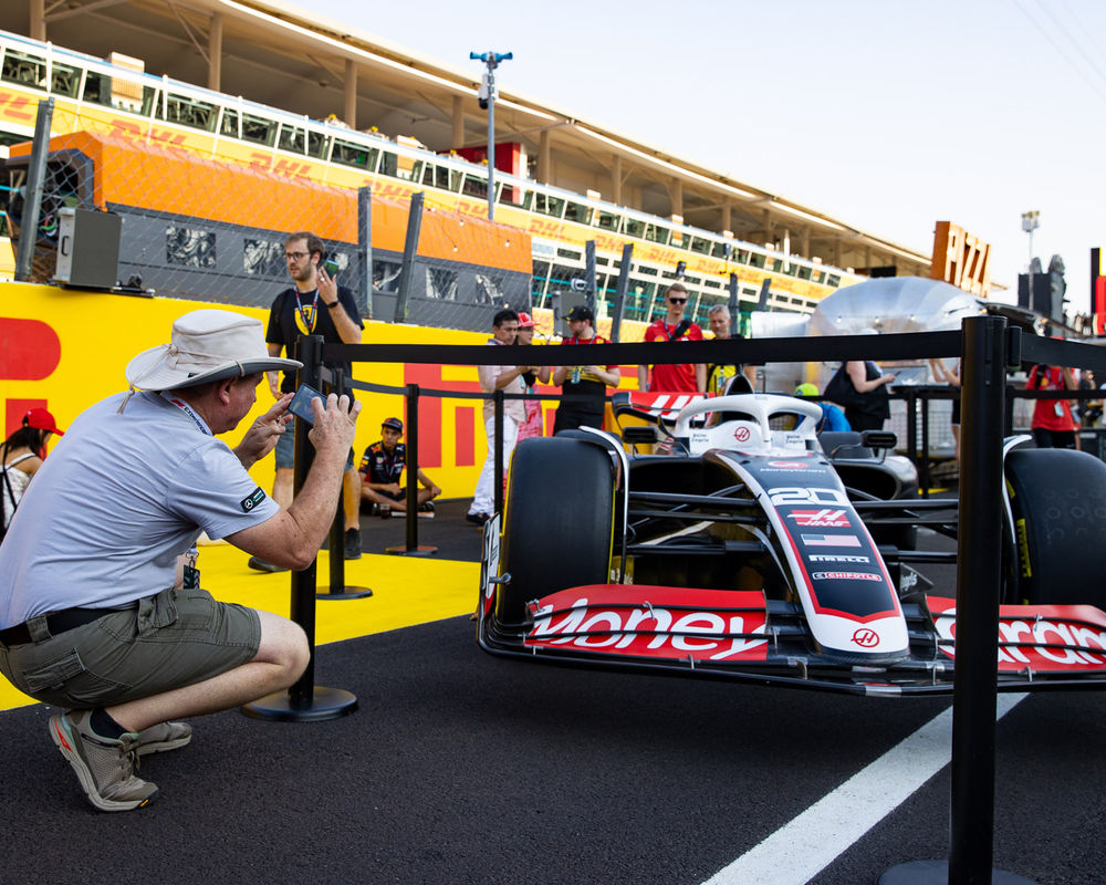 A Haas F1 car on display in the pit lane
