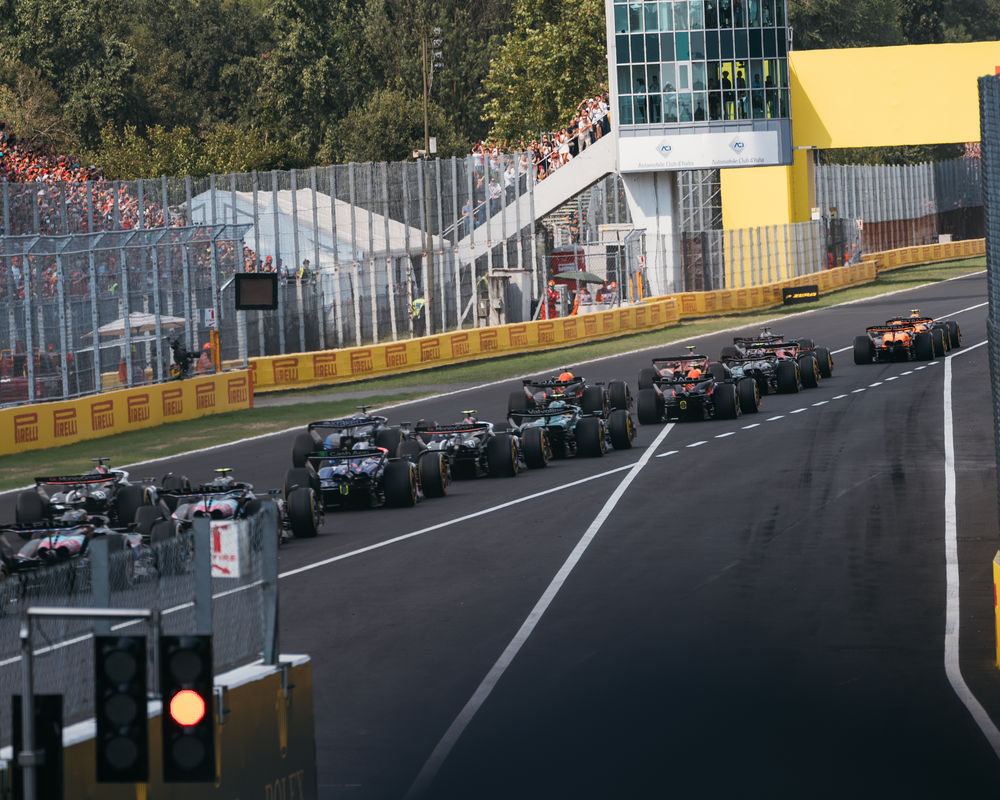 The F1 cars racing by during the start of the Italian GP