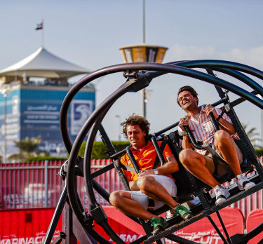 Two men on a rollercoaster ride on Yas Island at the Abu Dhabi Grand Prix