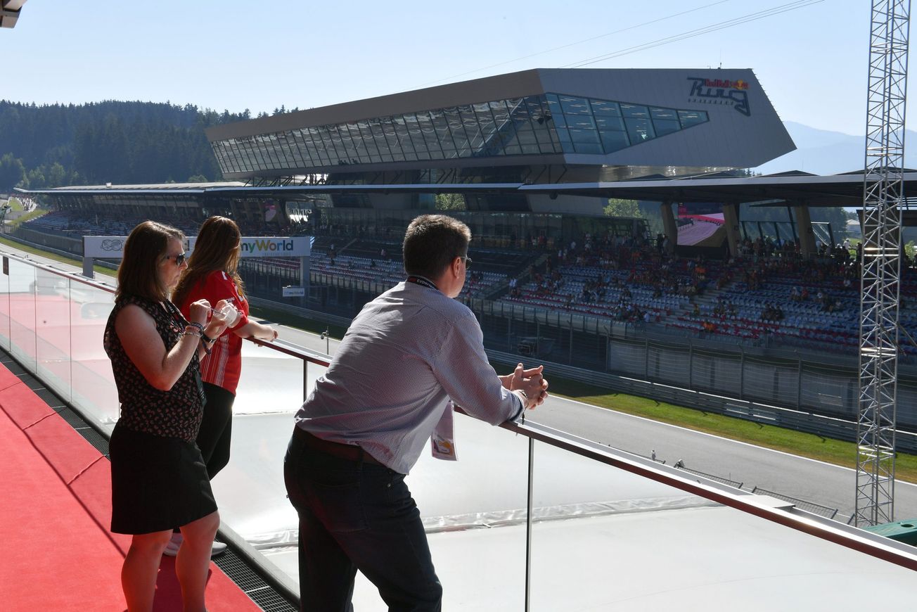 Champions Club guests overlooking the circuit from the outside terrace of the lounge
