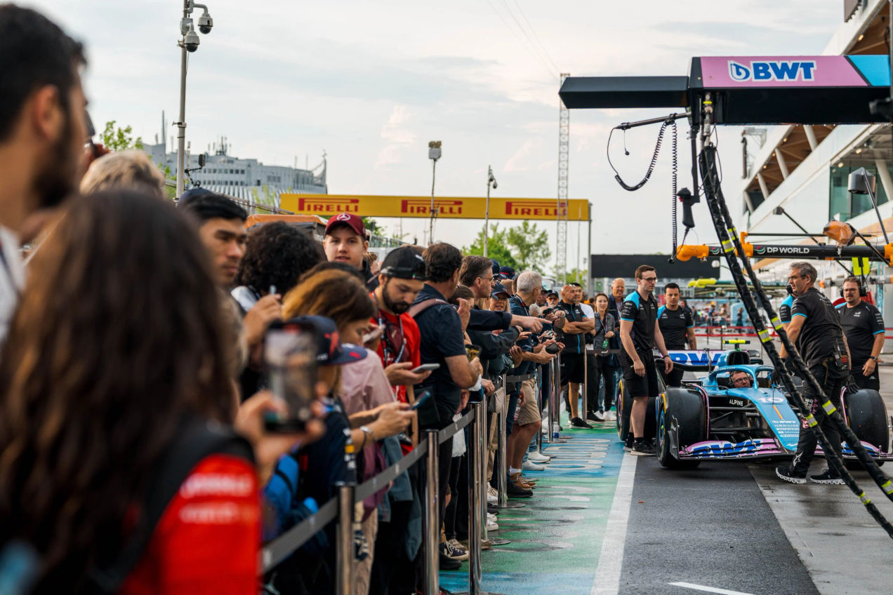 Formula One Fans watch a demonstration on a Formula One race car during a pit lane walk