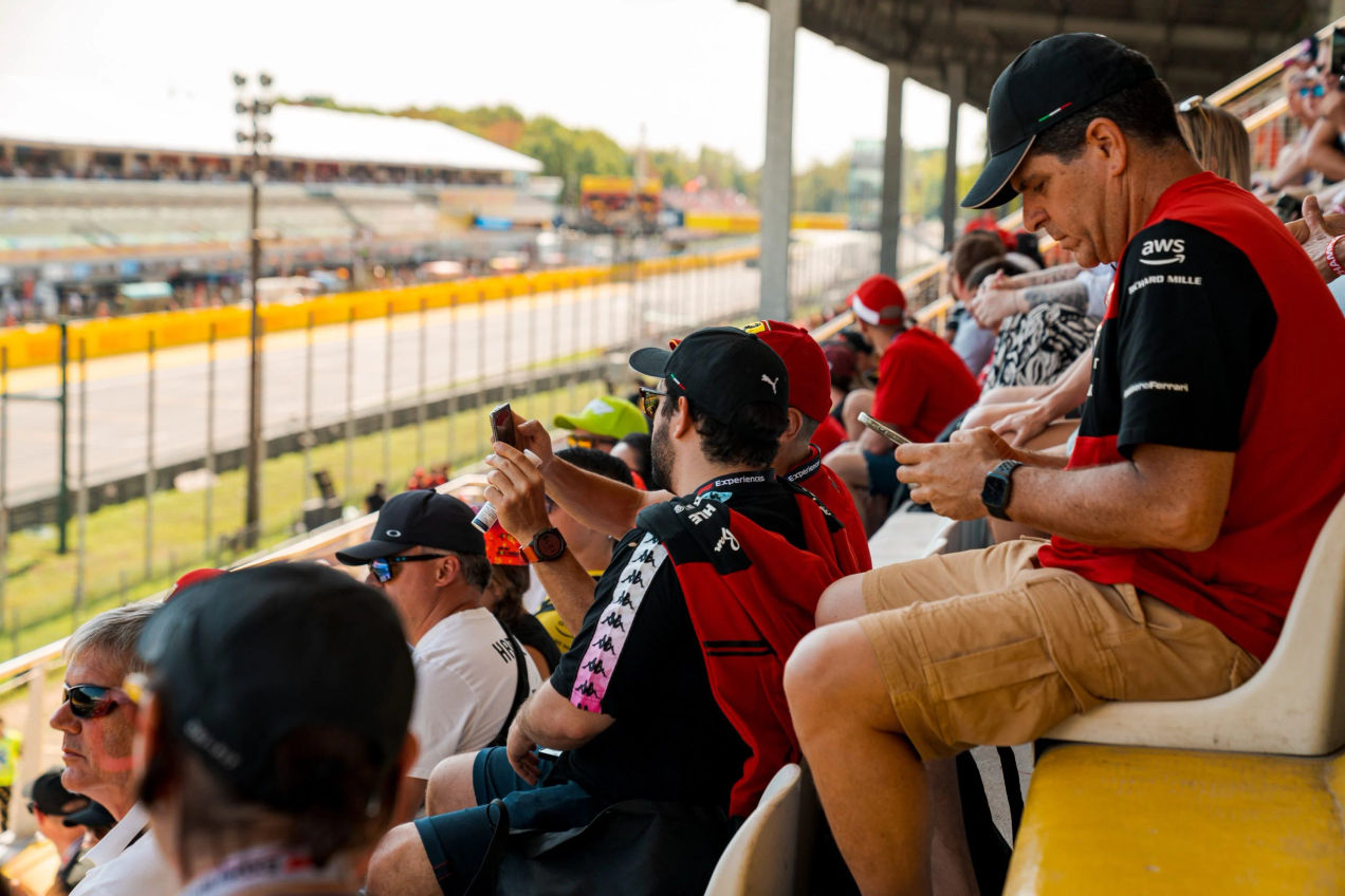 F1 Fans sitting on a covered grandstand by the starting grid at the Italian GP