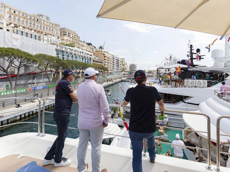 Guests aboard a luxury yacht look over the circuit at the Monaco GP