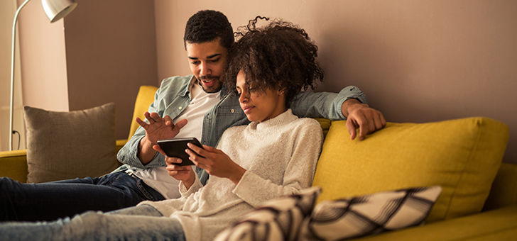 Couple on a home search using a tablet