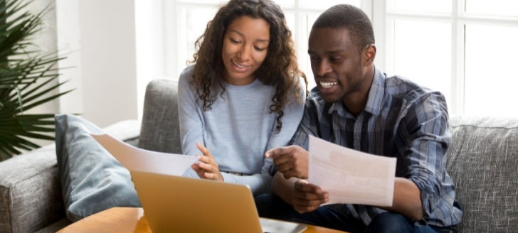 Husband and wife going over paperwork together.