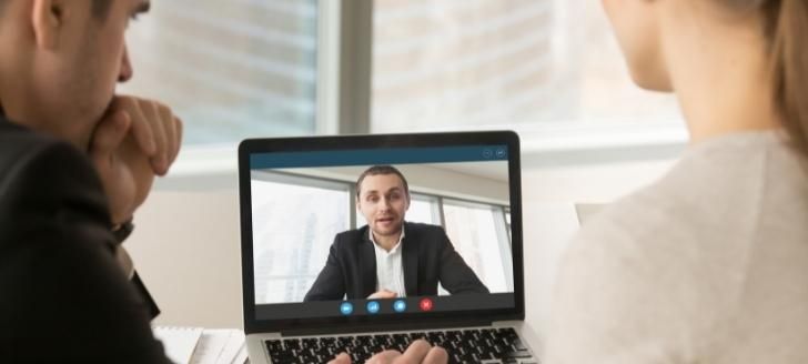 Employees having a meeting over video conference