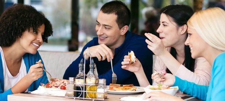 Diverse group of friends eating outdoors