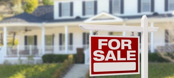 For sale sign in front of a house