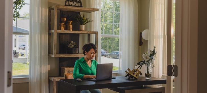 a woman using a laptop in a home office