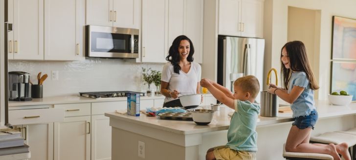 a family cooking dinner in the kitchen together