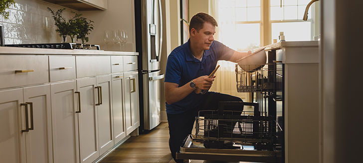 man loading dishwasher