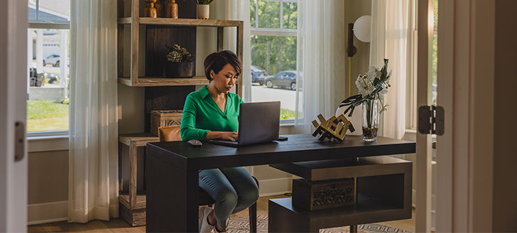 woman working on a laptop in a home office