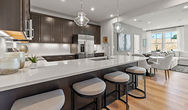 Design Collection Signature C includes: Barnett Painted Harbor Cabinets, Pure White Quartz Counter Tops, Kohler Finishes, GE Appliances, Ocean Shore LVP