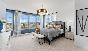 large primary bedroom with bright windows