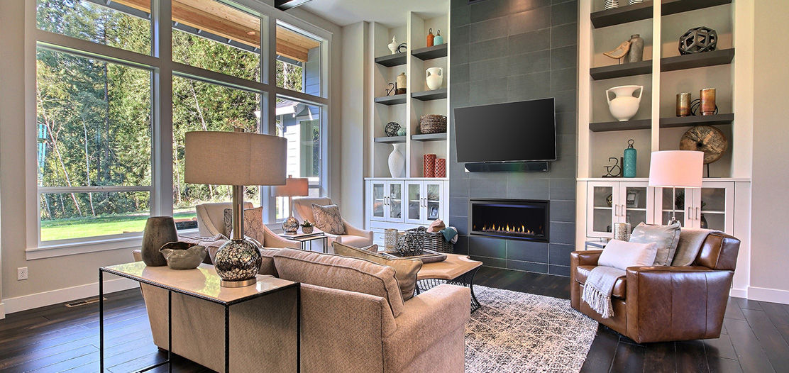 Living room and fireplace with mounted TV.