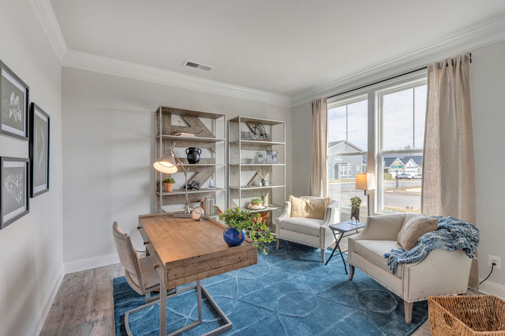 home office with desk shelves and seating