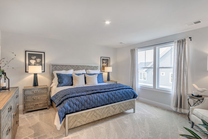 primary bedroom with large bed and furniture