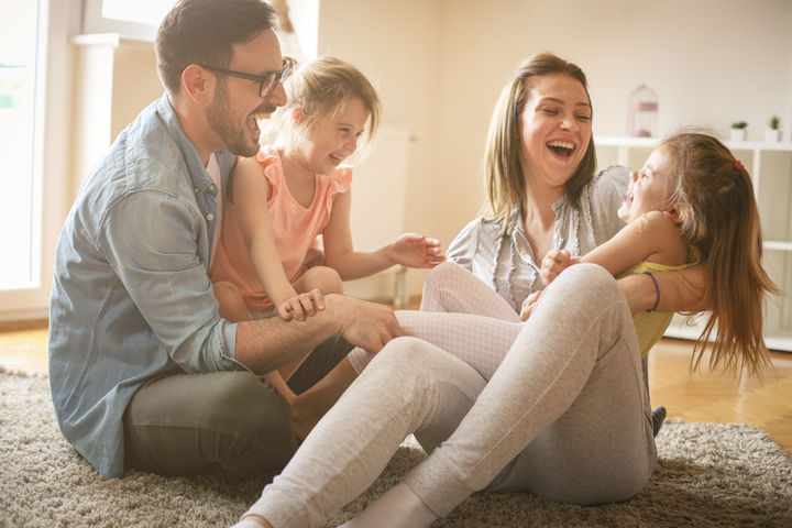 happy family on floor in new home