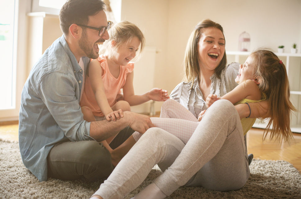 happy family on floor in new home