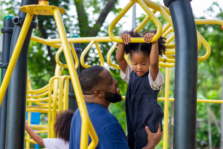 parent and child playing on playground