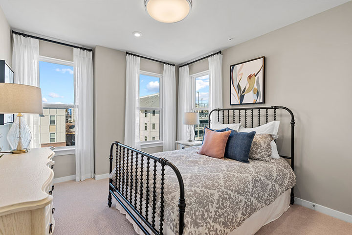 secondary bedroom with bright windows and large bed