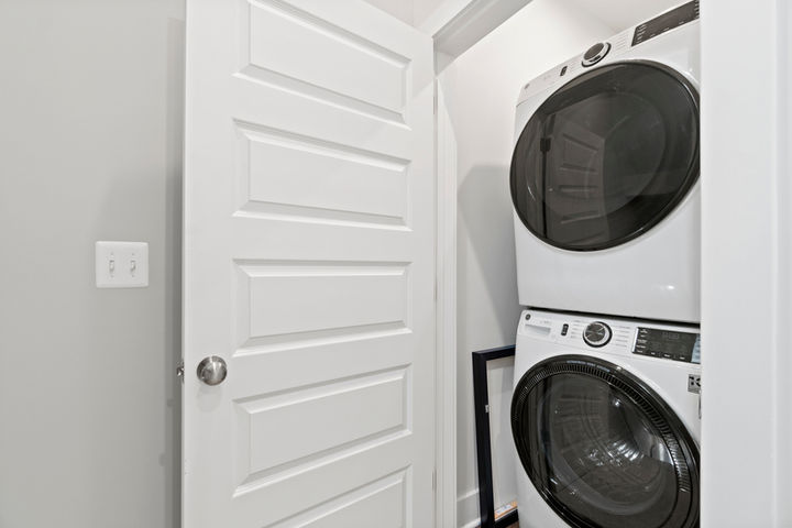 laundry room with stacked washer dryer