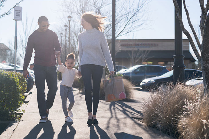 young family walking home