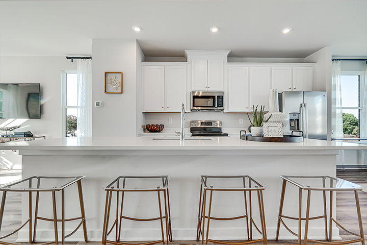bright white kitchen with counter seating at island
