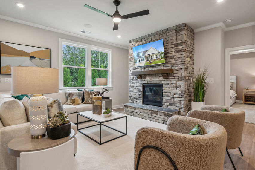 White kitchen with an island and bar seating next to a dining area.