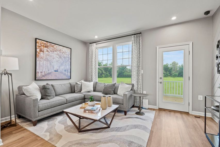 family room for entertainment with large sectional couch and bright windows