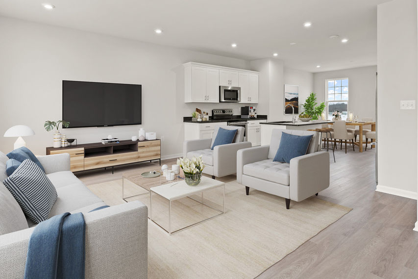 vast open space in main level with family room flowing to kitchen