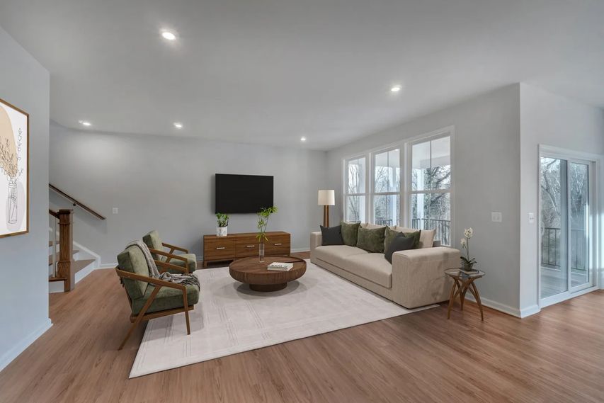 bedroom with bed between bright windows
