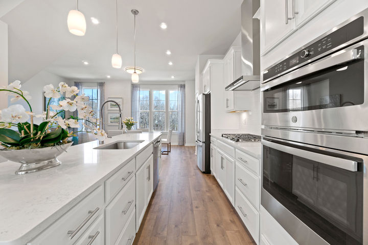 kitchen with double oven and sink in island