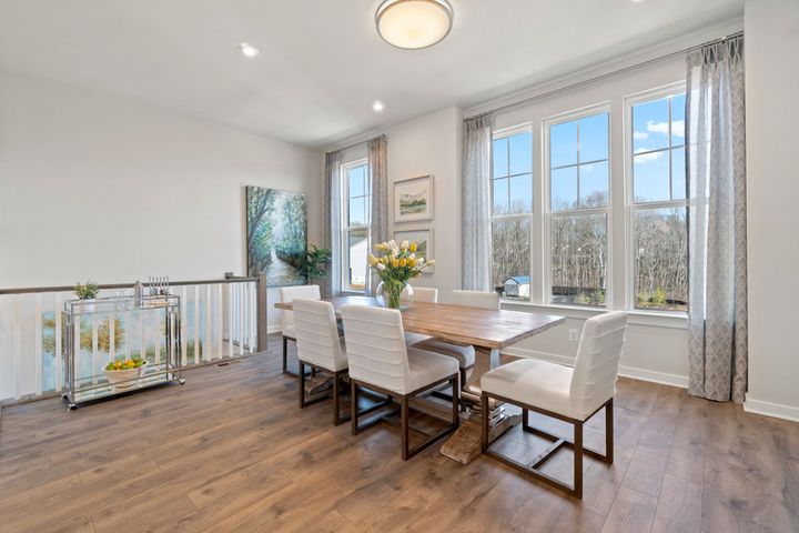 dining area with large table and bright windows