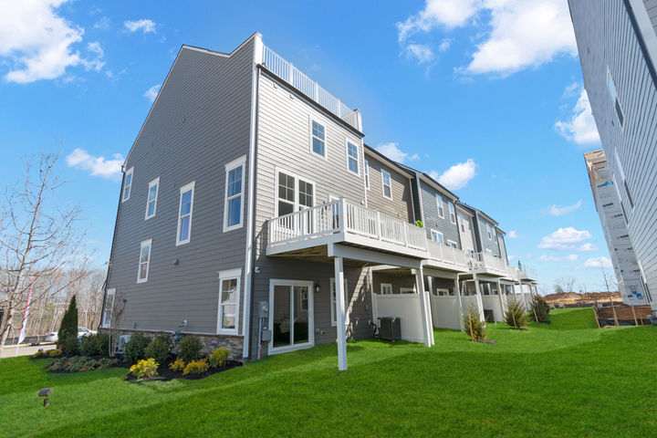 rear exterior with deck and rooftop terrace