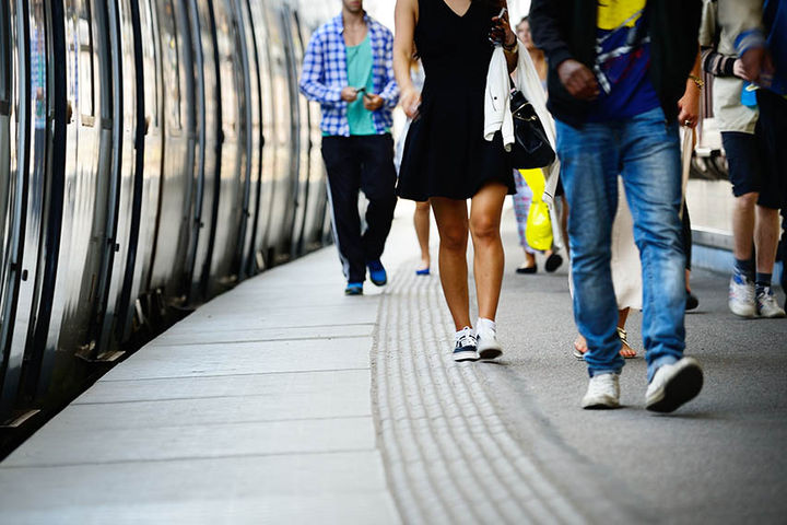 commuters walking off train at station