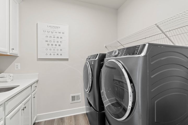 laundry room with shelving cabinets and sink