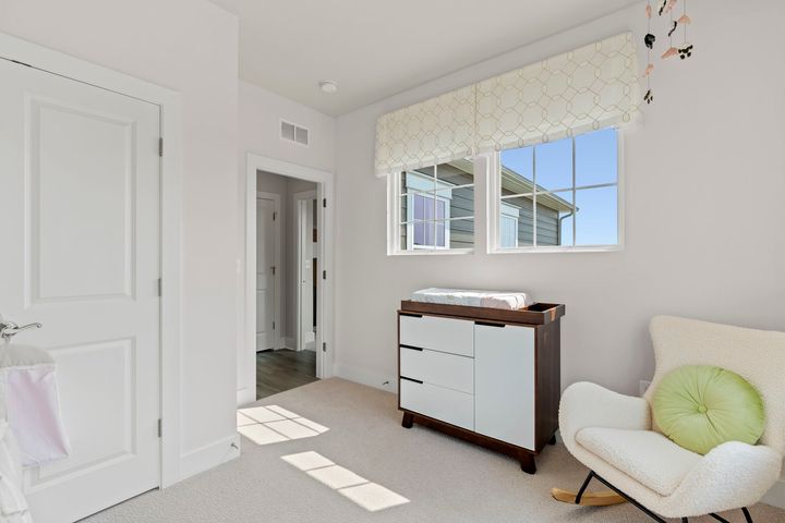 bedroom 4 with two windows and light color carpet