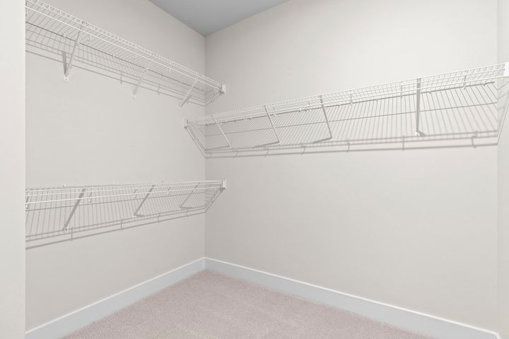 large closet with wire shelving and rack