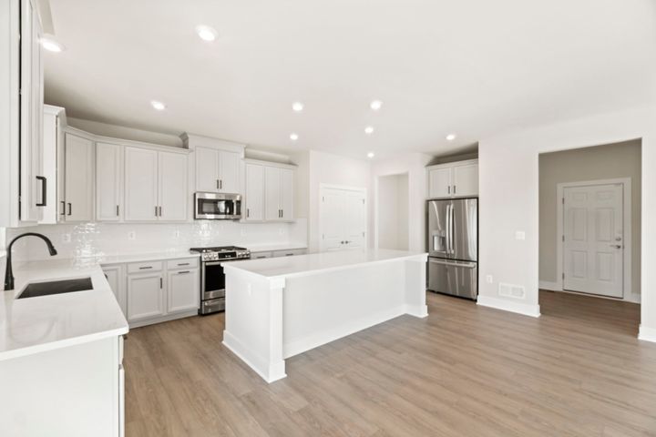 white kitchen with stainless steel appliances