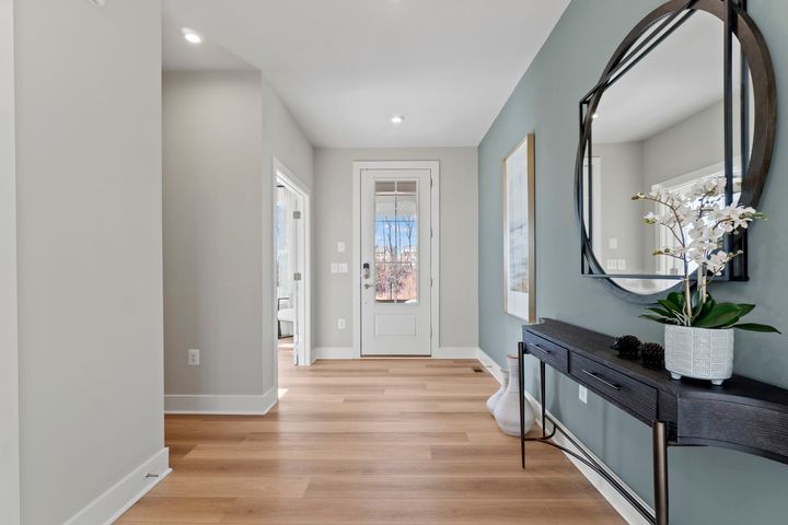 table and mirror in long foyer