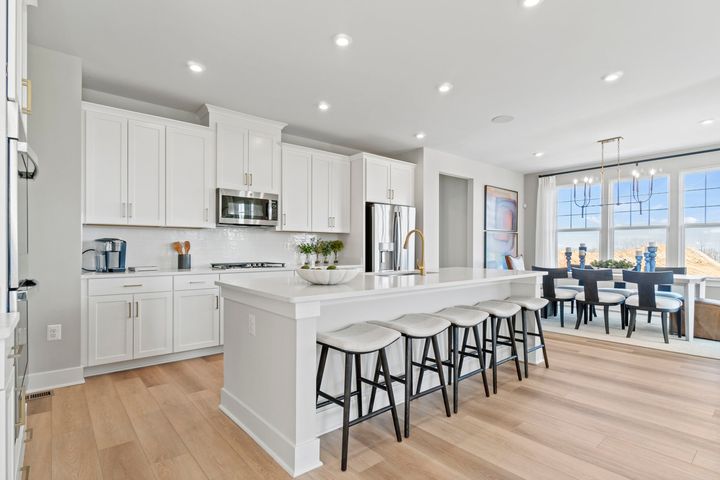 kitchen with large island and 5 stools