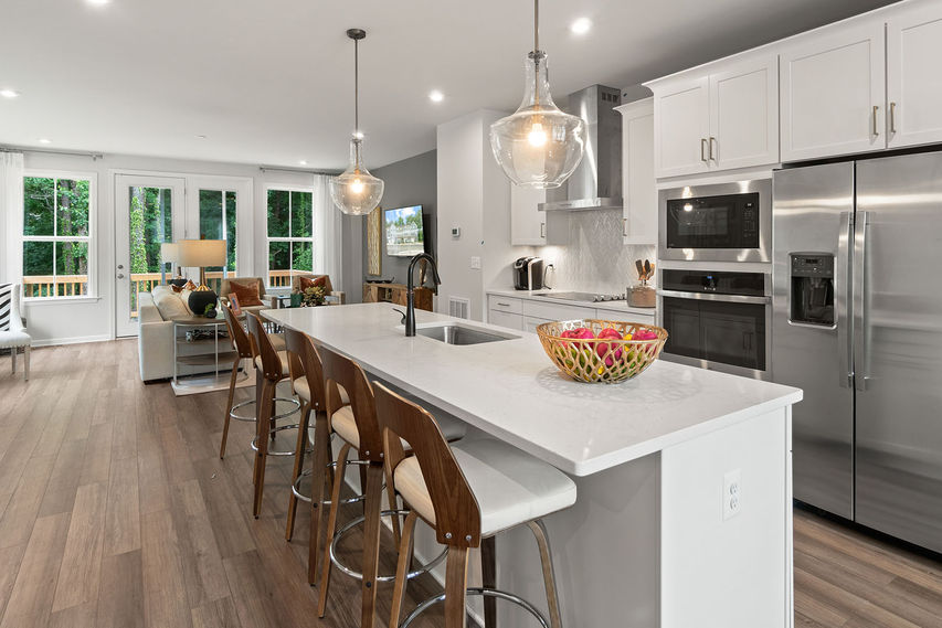 Kitchen with an island overlooking a living space in The Balfour