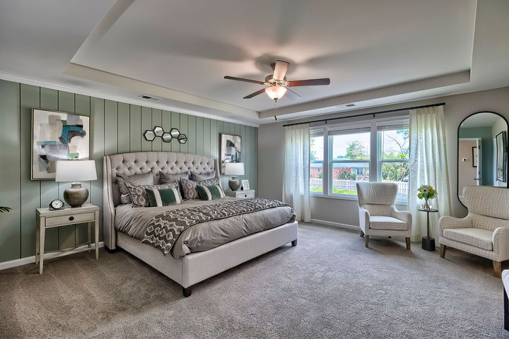 Step into our spacious primary bedroom with a stunning tray ceiling, where luxury meets serenity