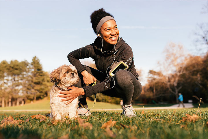 woman with dog on trail