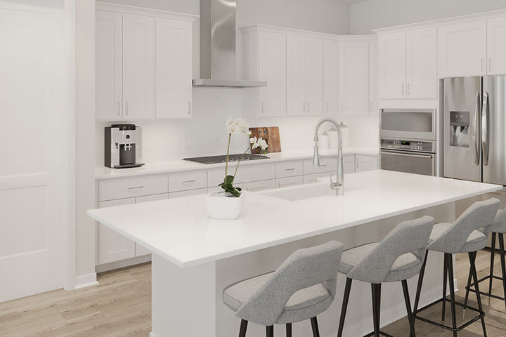 bright white kitchen with large island and counter seating