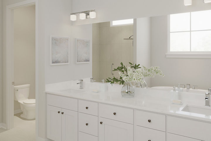 primary bathroom with cabinet vanity and dual sinks