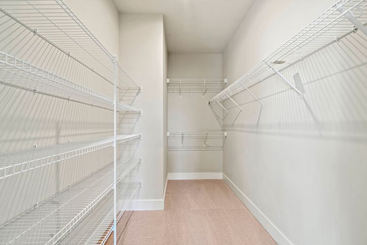 huge walk in closet with multi level shelving