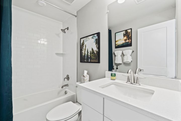 lower level full bath with tub shower and cabinet vanity